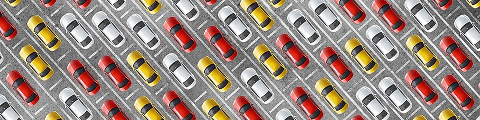 Cluster of red, yellow and white cars