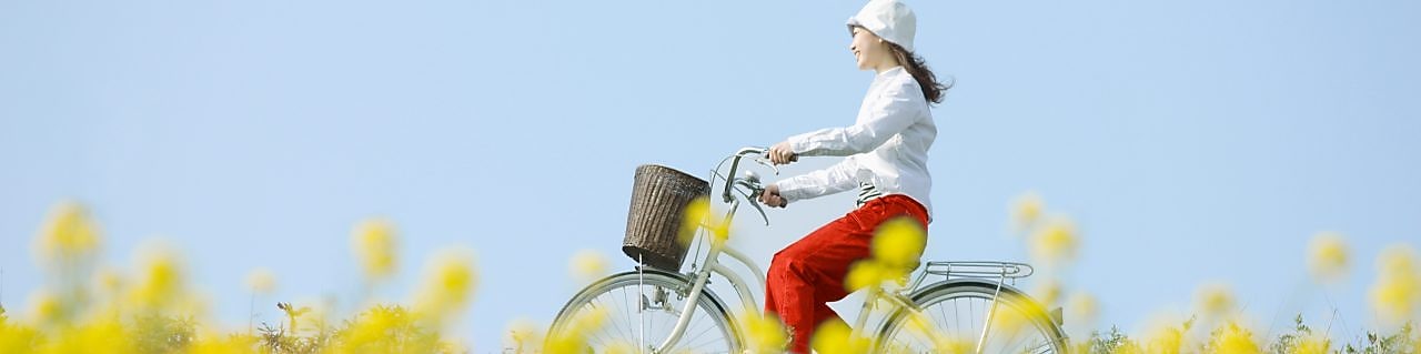 Genç bir kadın yazlık bir mesire alanında bisiklet sürüyor