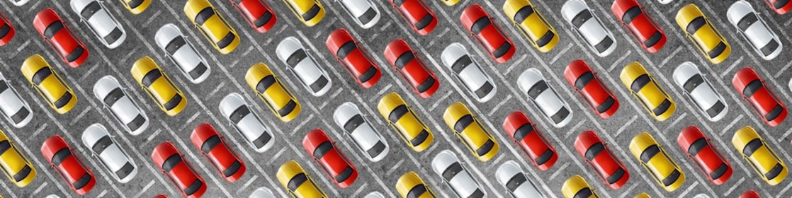 Cluster of red, yellow and white cars