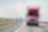 Red and white trucks on the road