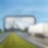 Ein Lkw fährt durch ein fiktives Tor in die Berge.