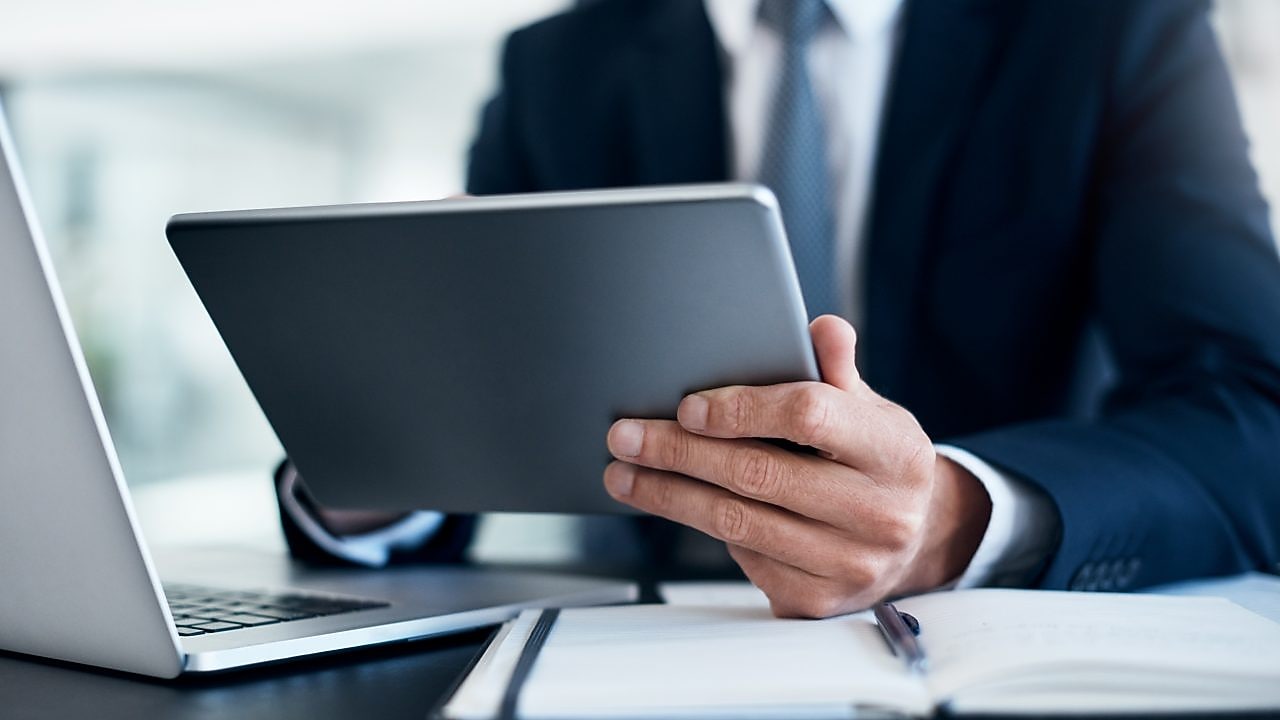 man working on tablets