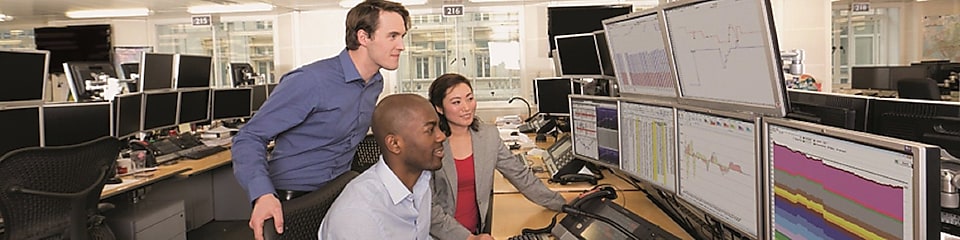 Verileri çoklu bilgisayar ekranlarından inceleyen Ticaret personeli