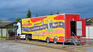 Kids holding placards with the name of the Road Safety project on it