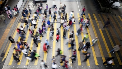 Hong Kong'da işlek bir caddeden karşıya geçen insanlar
